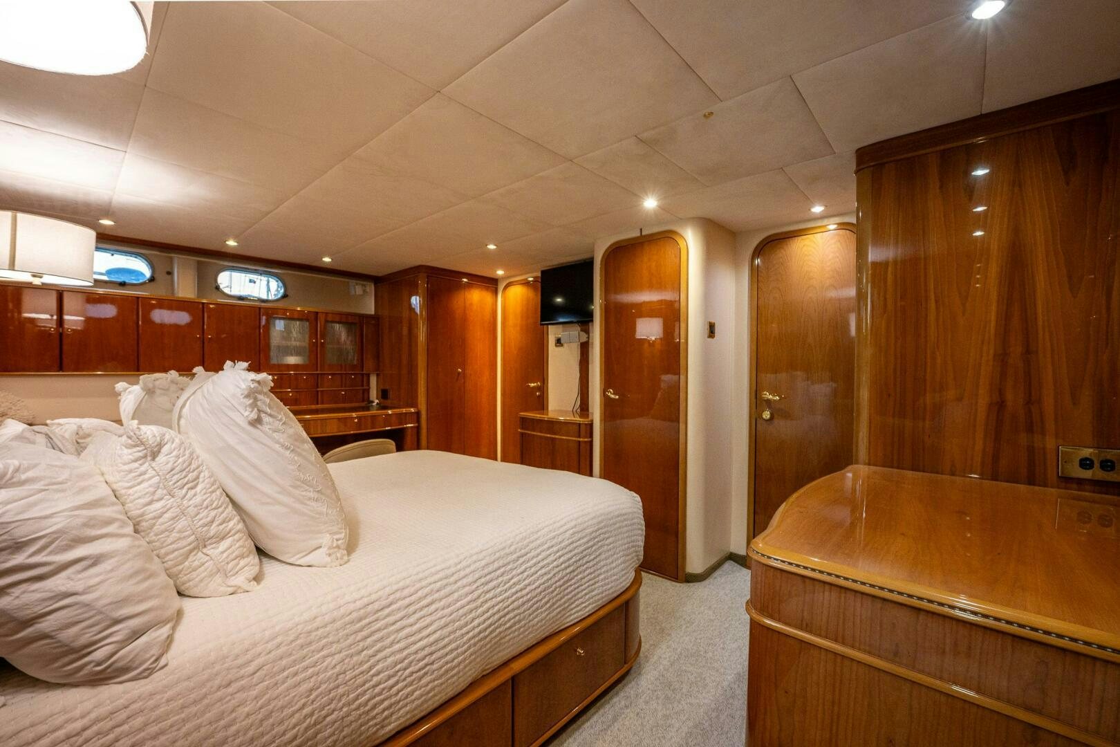 a room with a bed and a desk aboard PEARL Yacht for Sale