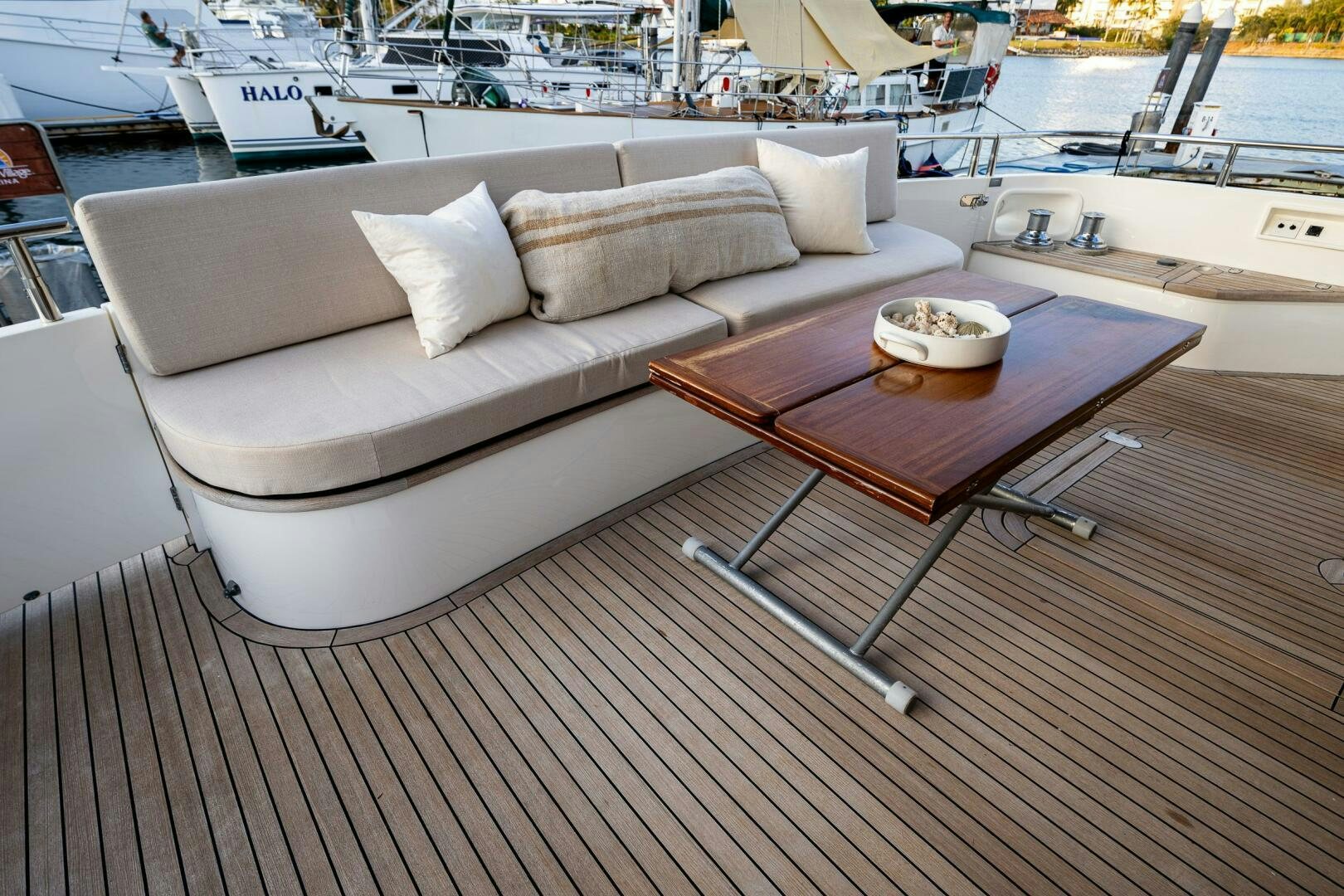 a couch and a table on a deck aboard PEARL Yacht for Sale