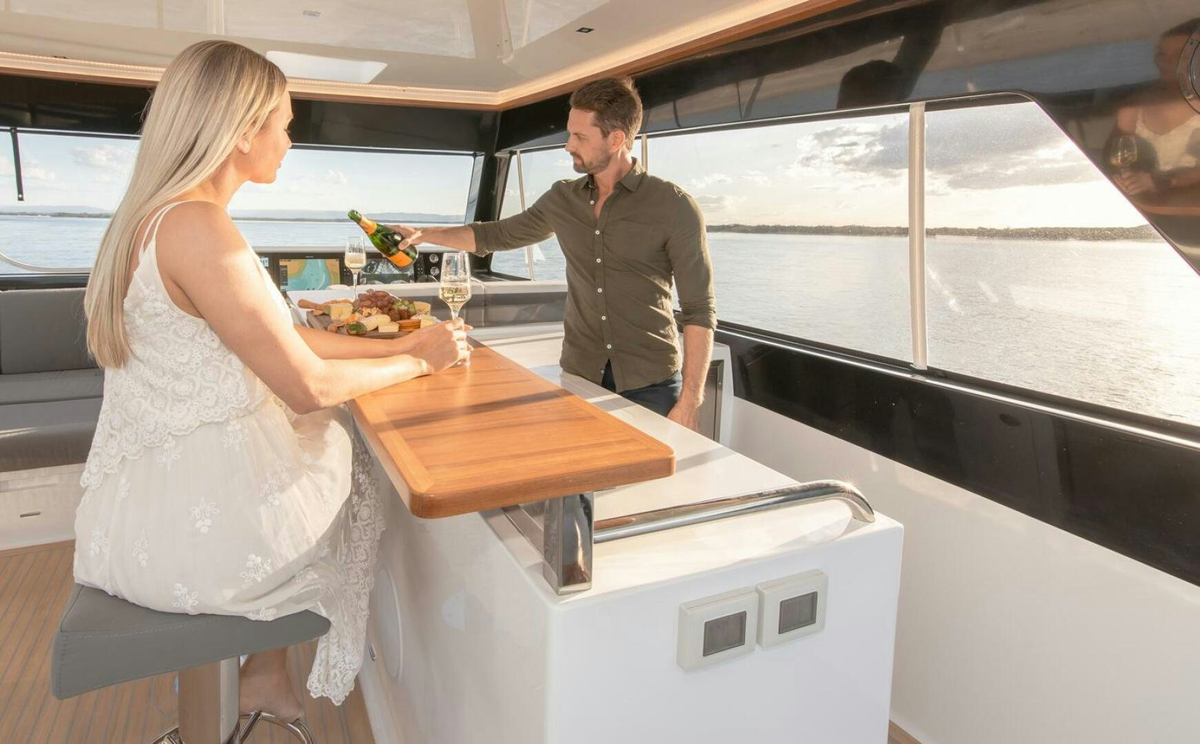 a man and woman serving food aboard NONE Yacht for Sale
