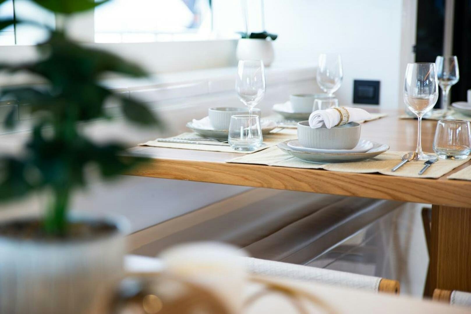 a table with plates and glasses aboard NONE Yacht for Sale
