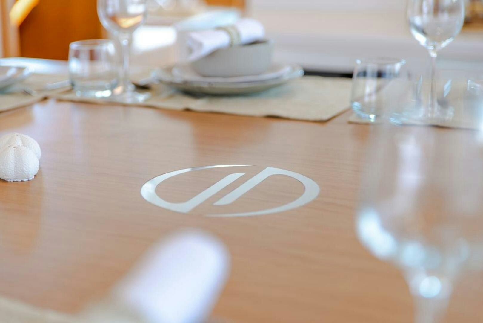 a table with plates and glasses aboard NONE Yacht for Sale