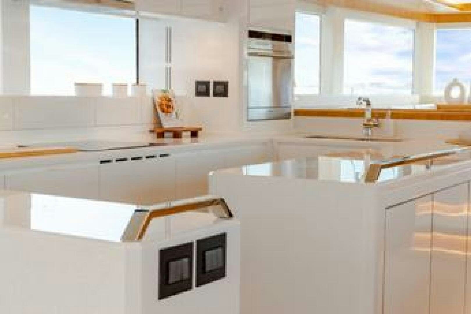 a kitchen with white cabinets aboard NONE Yacht for Sale