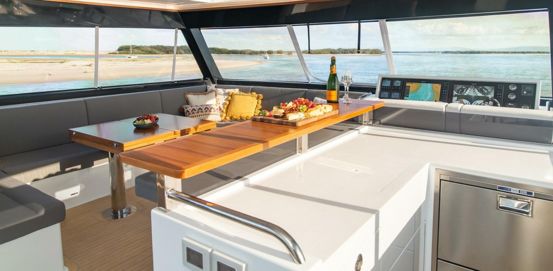 a kitchen with a table and a shelf with food on it aboard NONE Yacht for Sale