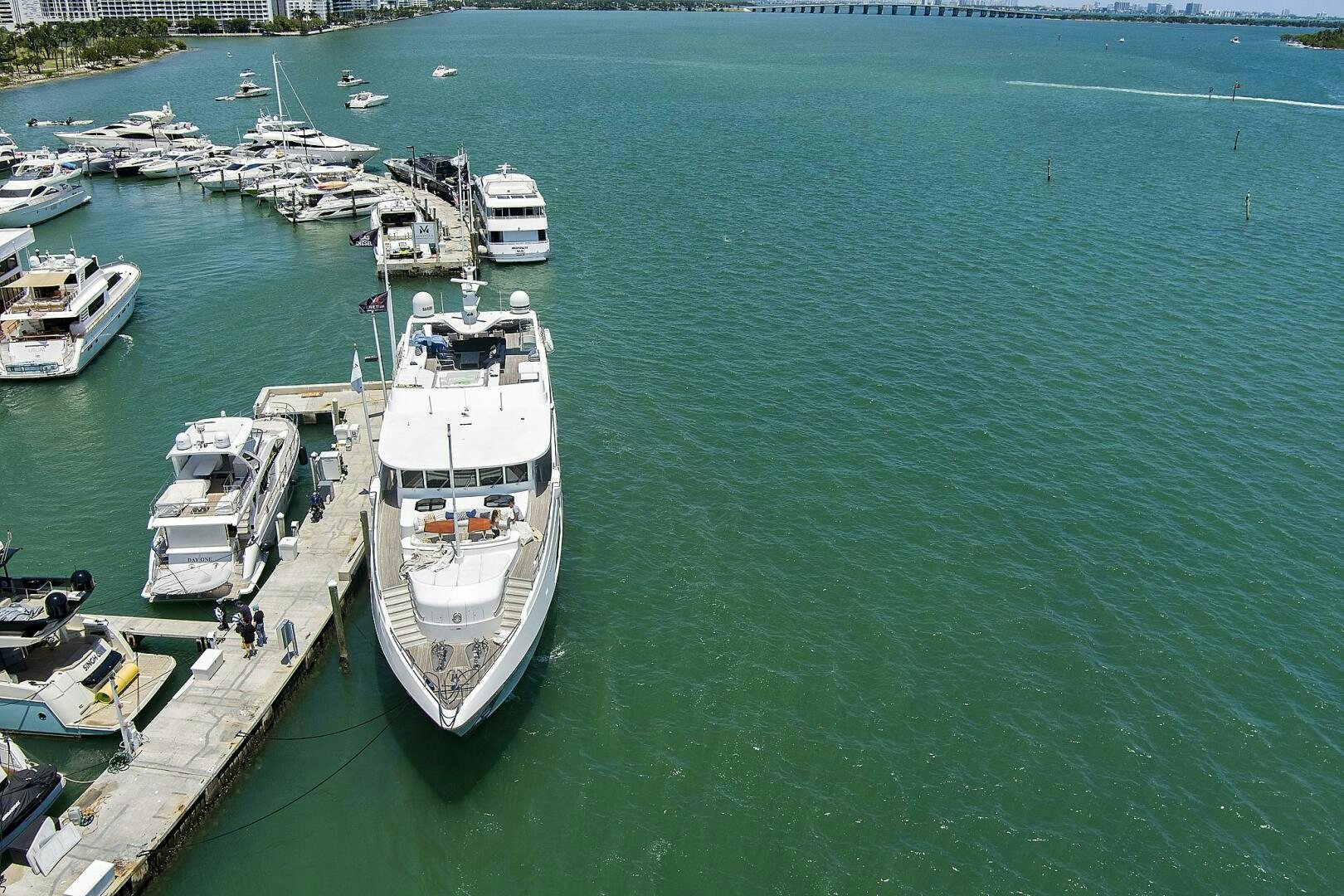 a large boat is parked on the side of a river aboard SWEET CAROLINE Yacht for Sale