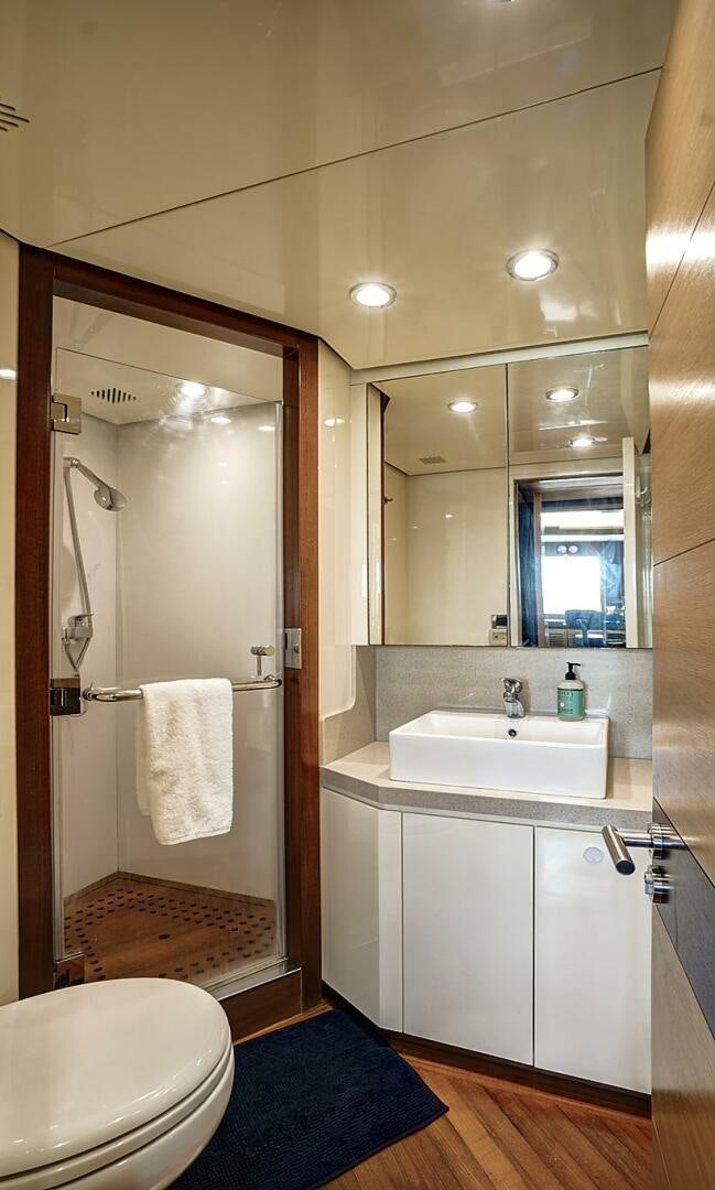 a bathroom with a glass shower door aboard SWEET CAROLINE Yacht for Sale
