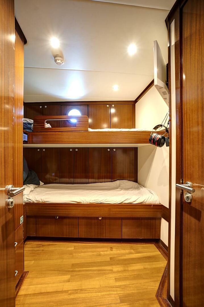 a bed with a wooden frame aboard SWEET CAROLINE Yacht for Sale
