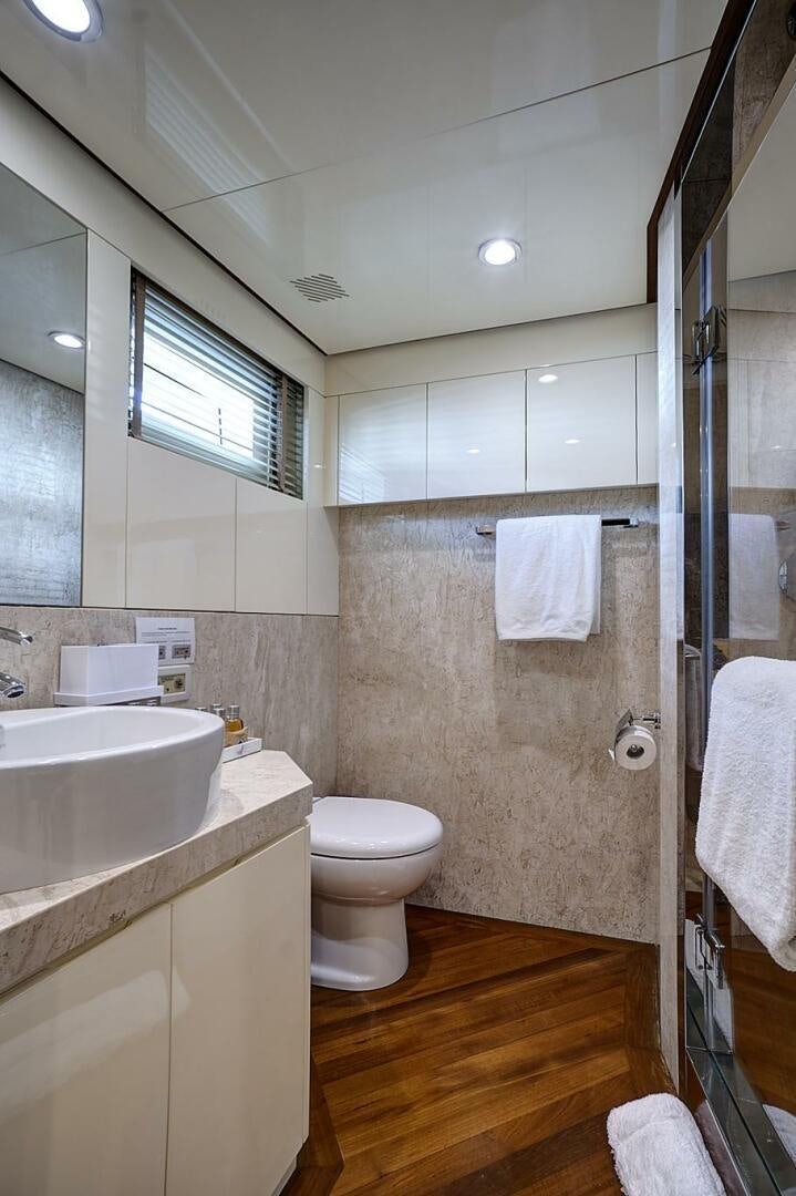 a bathroom with a sink toilet and a shower unit aboard SWEET CAROLINE Yacht for Sale