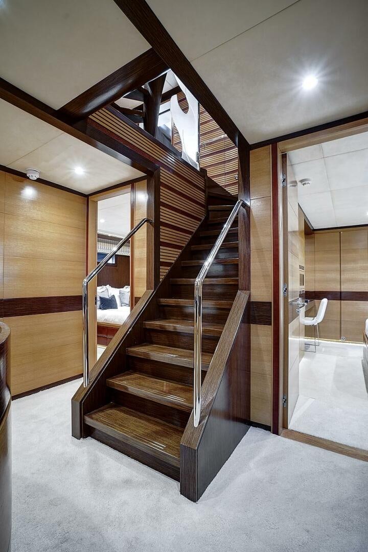 a wooden staircase in a house aboard SWEET CAROLINE Yacht for Sale