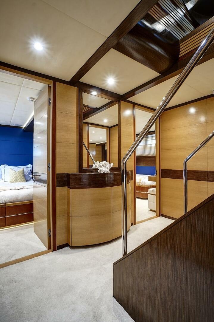 a room with a bed and a mirror aboard SWEET CAROLINE Yacht for Sale