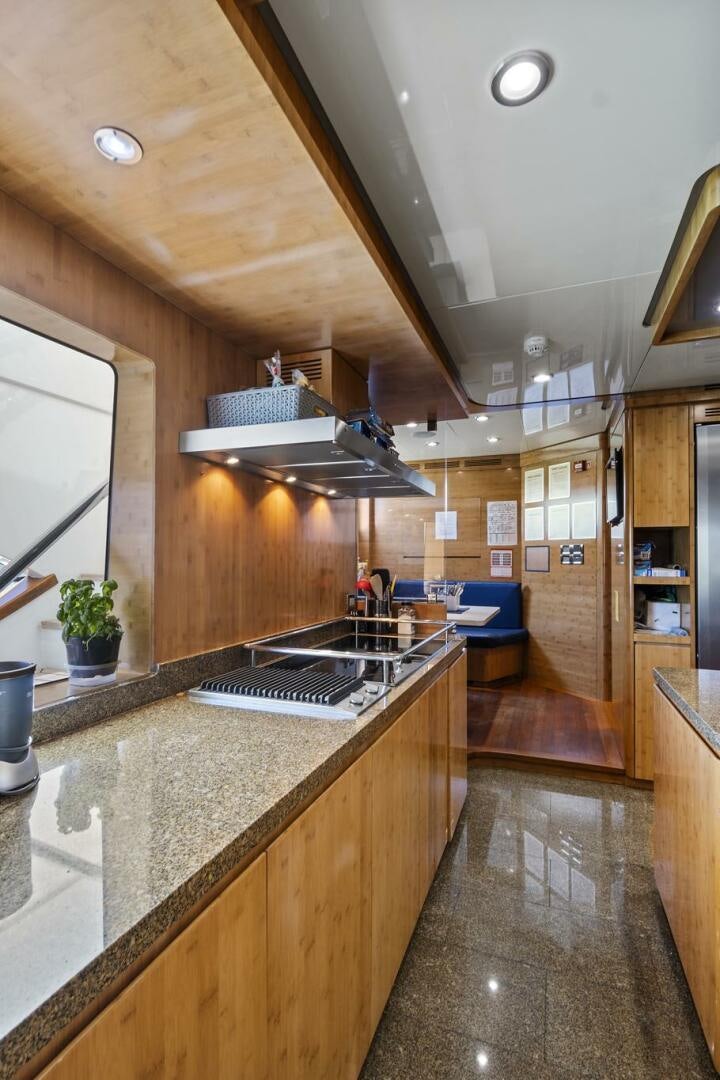a kitchen with a large island aboard SWEET CAROLINE Yacht for Sale