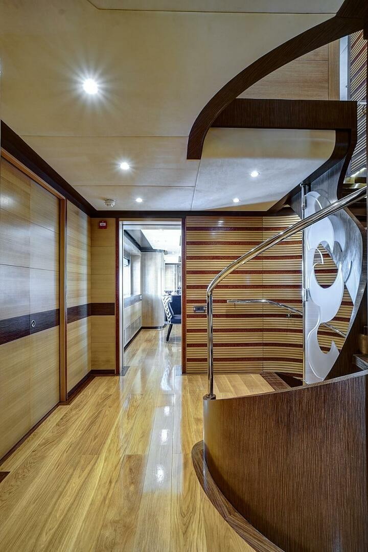 a room with wooden floors and a staircase aboard SWEET CAROLINE Yacht for Sale