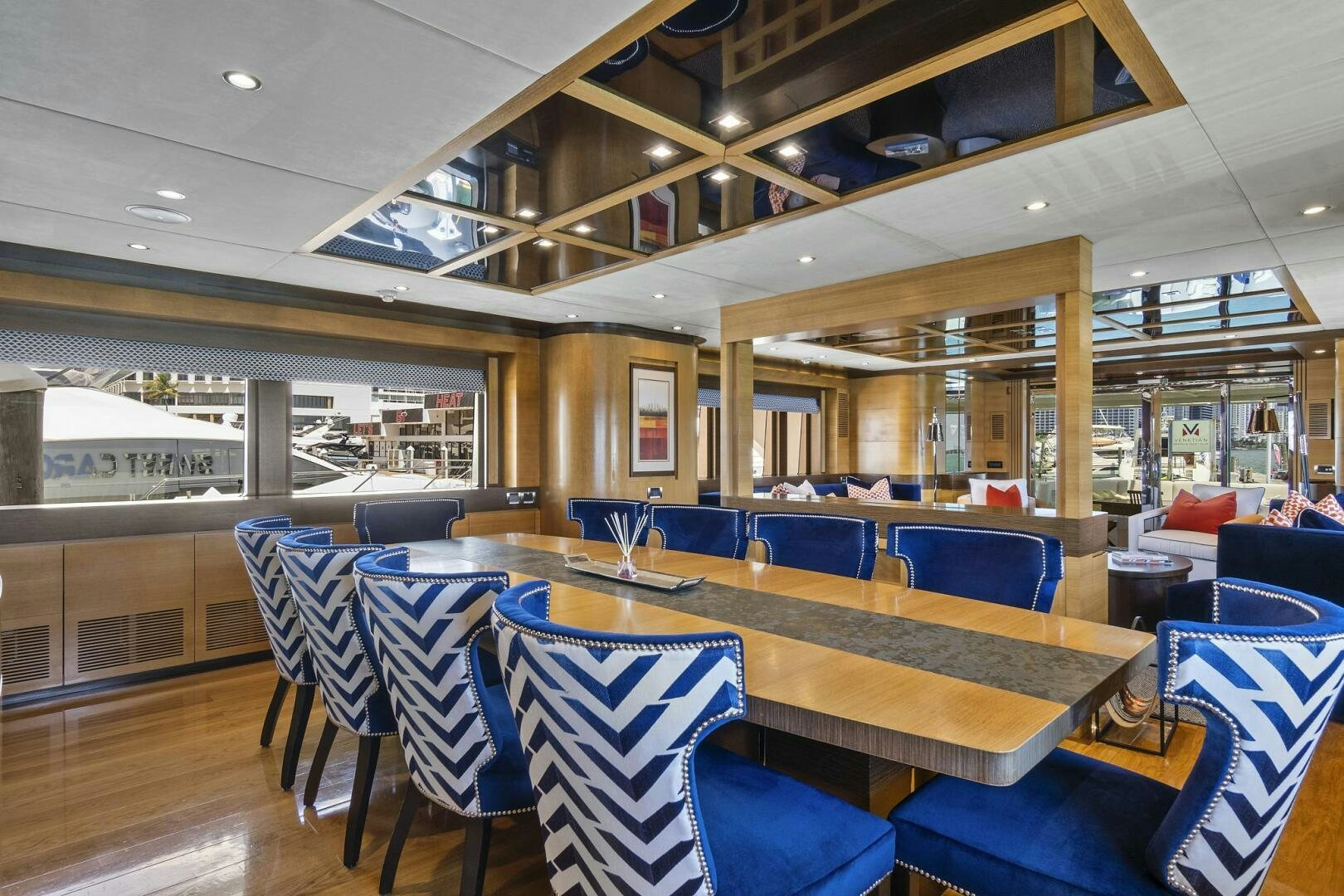 a room with tables and chairs aboard SWEET CAROLINE Yacht for Sale