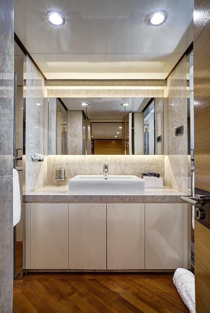 a bathroom with a sink and a mirror aboard SWEET CAROLINE Yacht for Sale