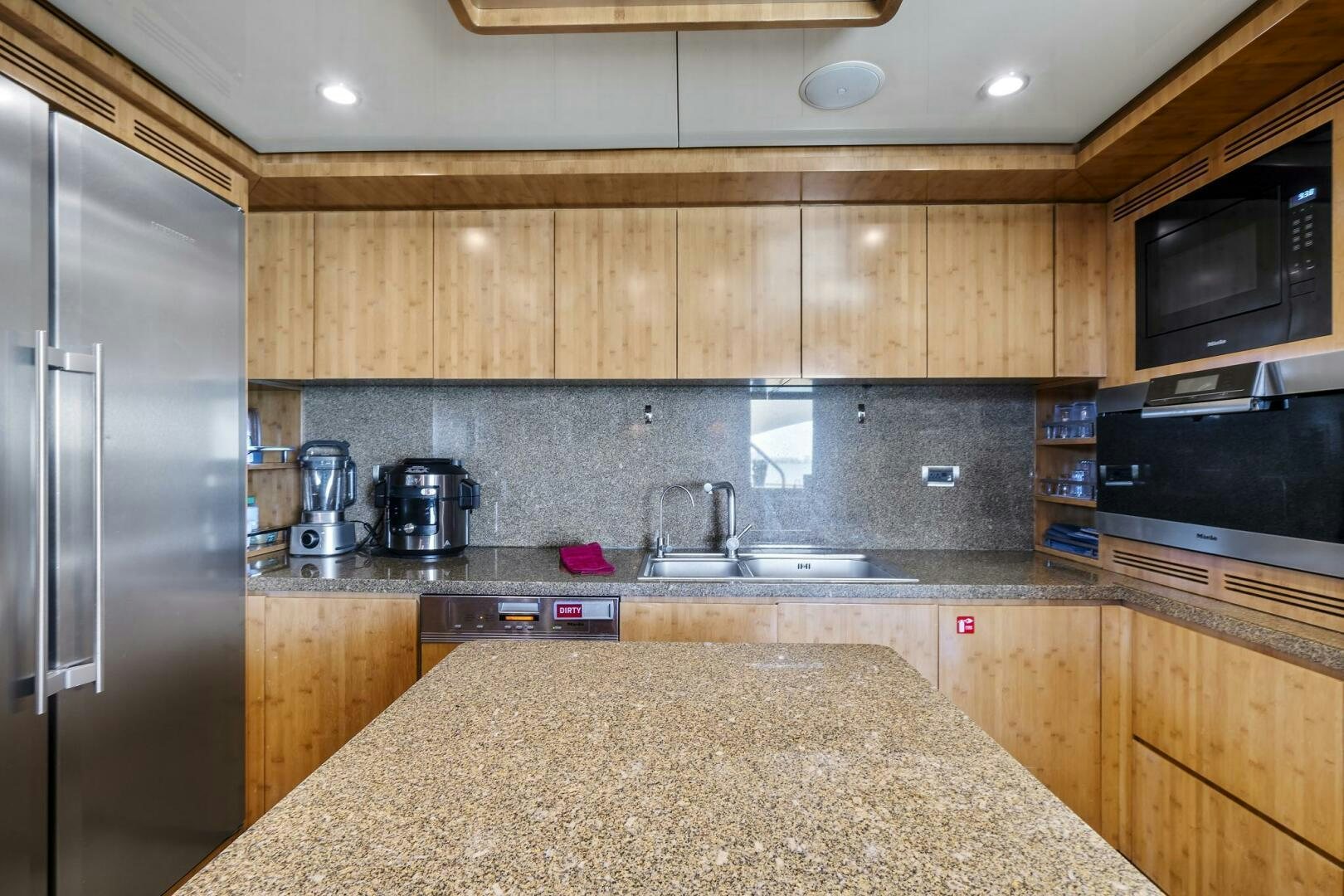 a kitchen with a marble counter top aboard SWEET CAROLINE Yacht for Sale
