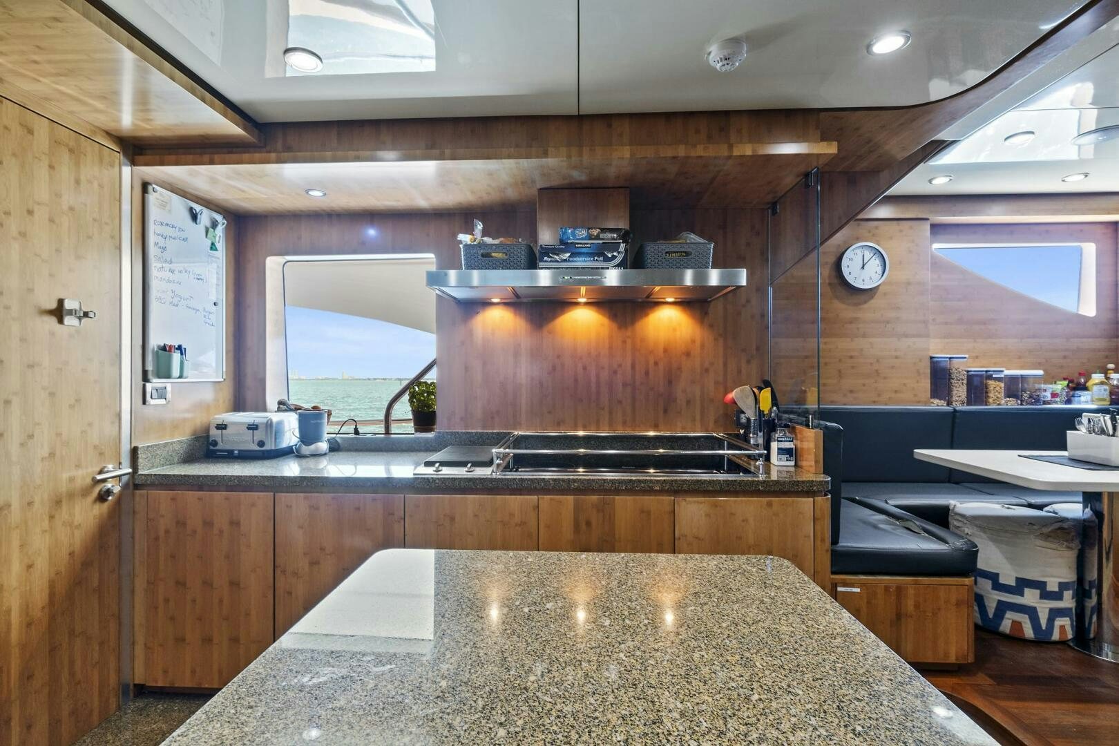 a kitchen with a large stone counter aboard SWEET CAROLINE Yacht for Sale