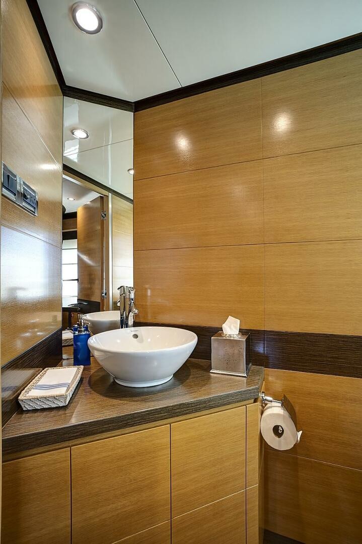 a bathroom with a sink and a mirror aboard SWEET CAROLINE Yacht for Sale