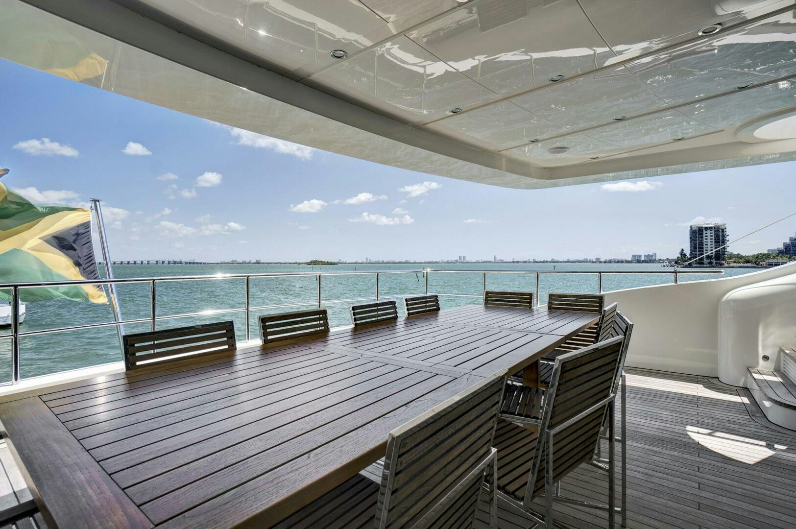 a deck with chairs and a body of water in the background aboard SWEET CAROLINE Yacht for Sale