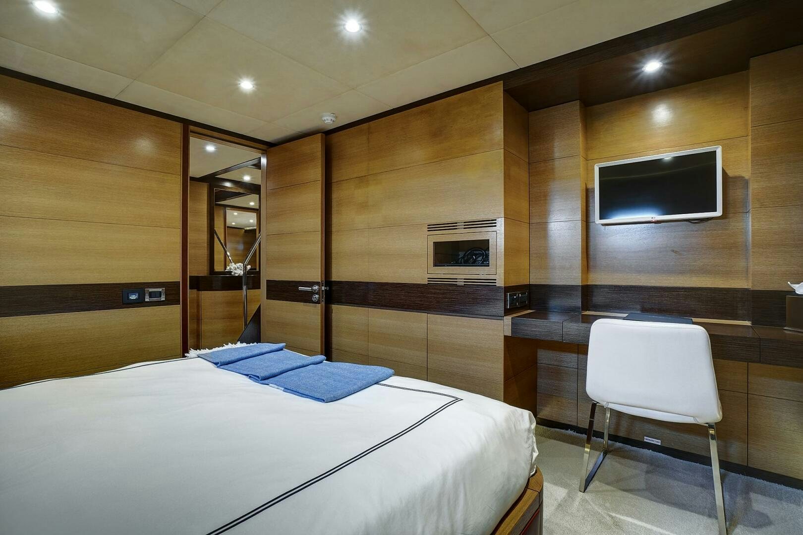 a room with a bed and desk aboard SWEET CAROLINE Yacht for Sale