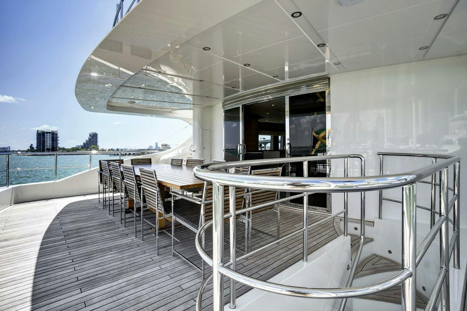 a deck with a table and chairs on it aboard SWEET CAROLINE Yacht for Sale