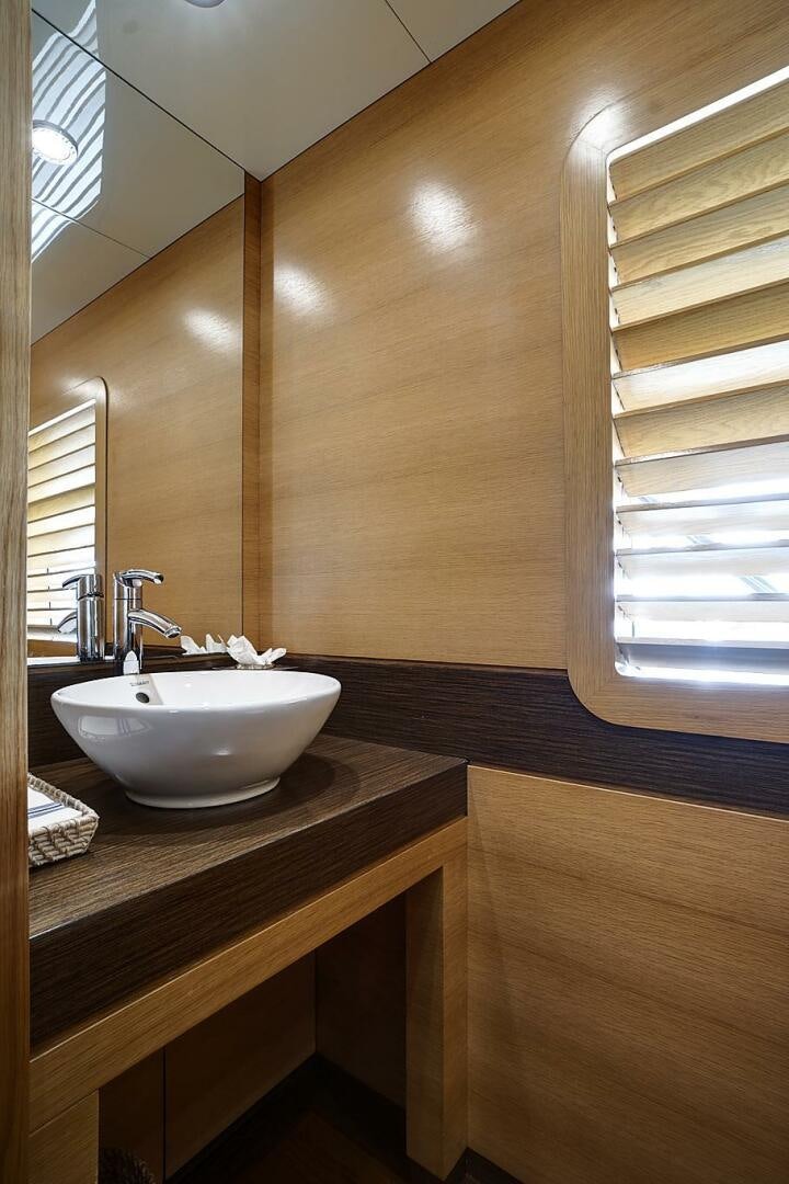 a bathroom with a sink and a mirror aboard SWEET CAROLINE Yacht for Sale