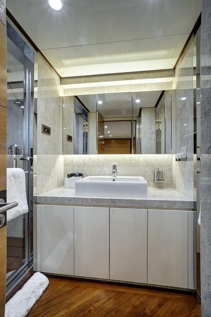 a bathroom with a sink and a mirror aboard SWEET CAROLINE Yacht for Sale