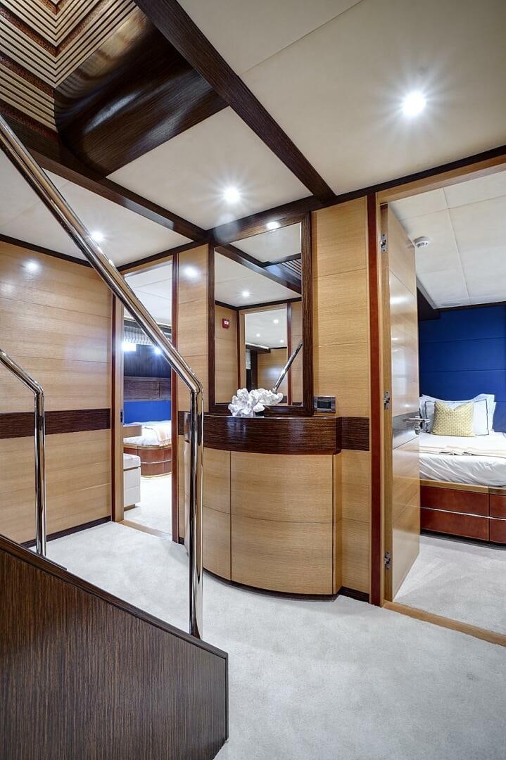 a room with a bed and a mirror aboard SWEET CAROLINE Yacht for Sale