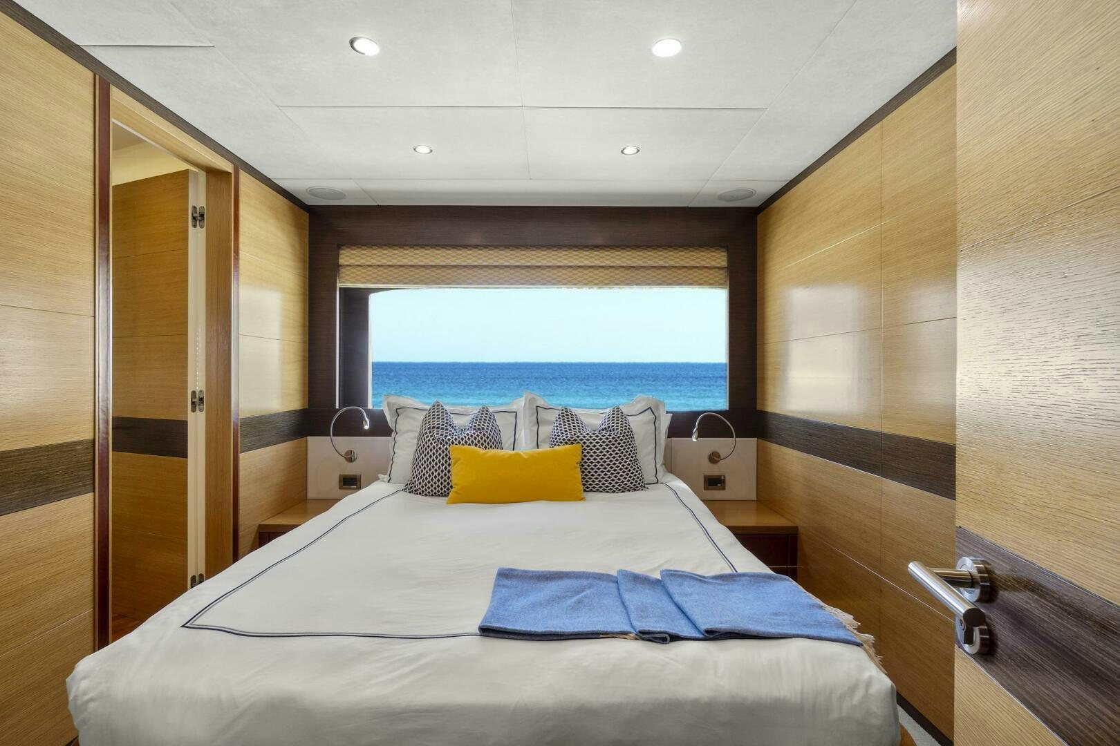 a bed with a large window aboard SWEET CAROLINE Yacht for Sale