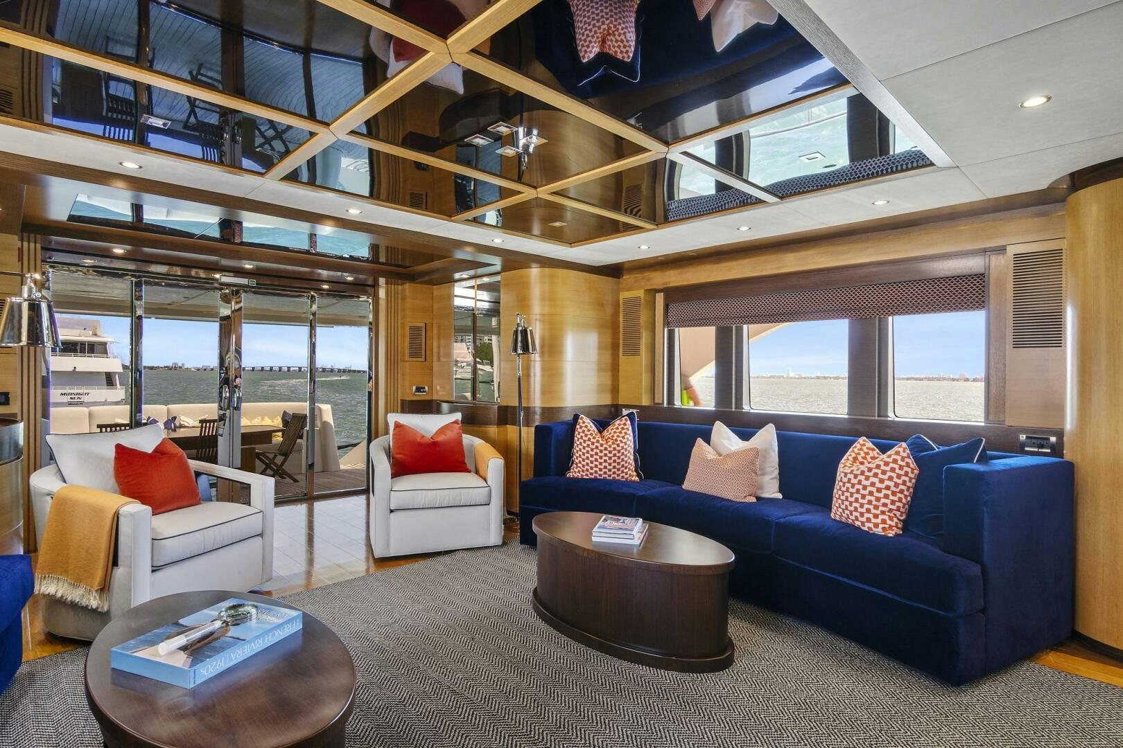 a living room with a blue couch aboard SWEET CAROLINE Yacht for Sale