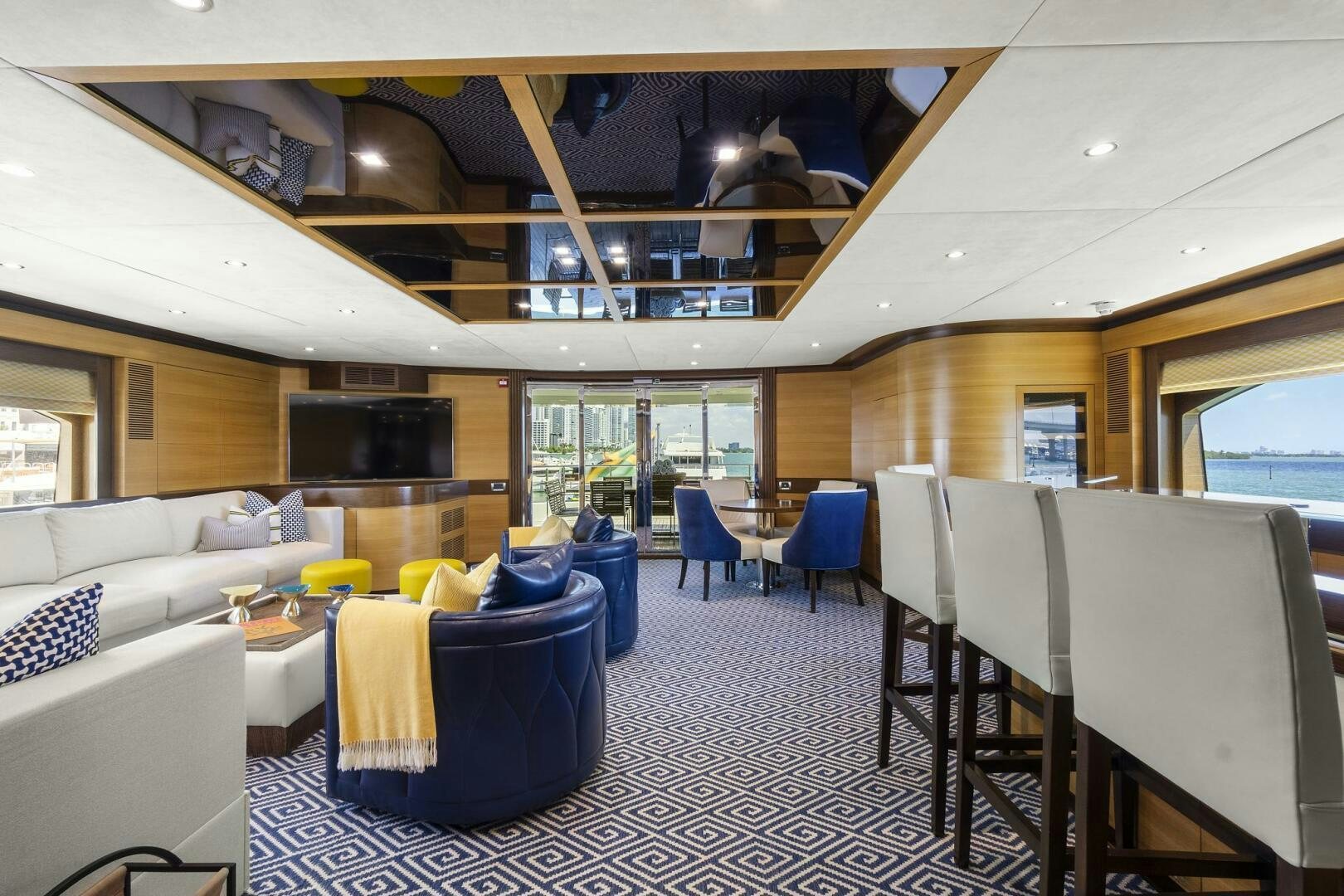a room with tables chairs and a couch aboard SWEET CAROLINE Yacht for Sale