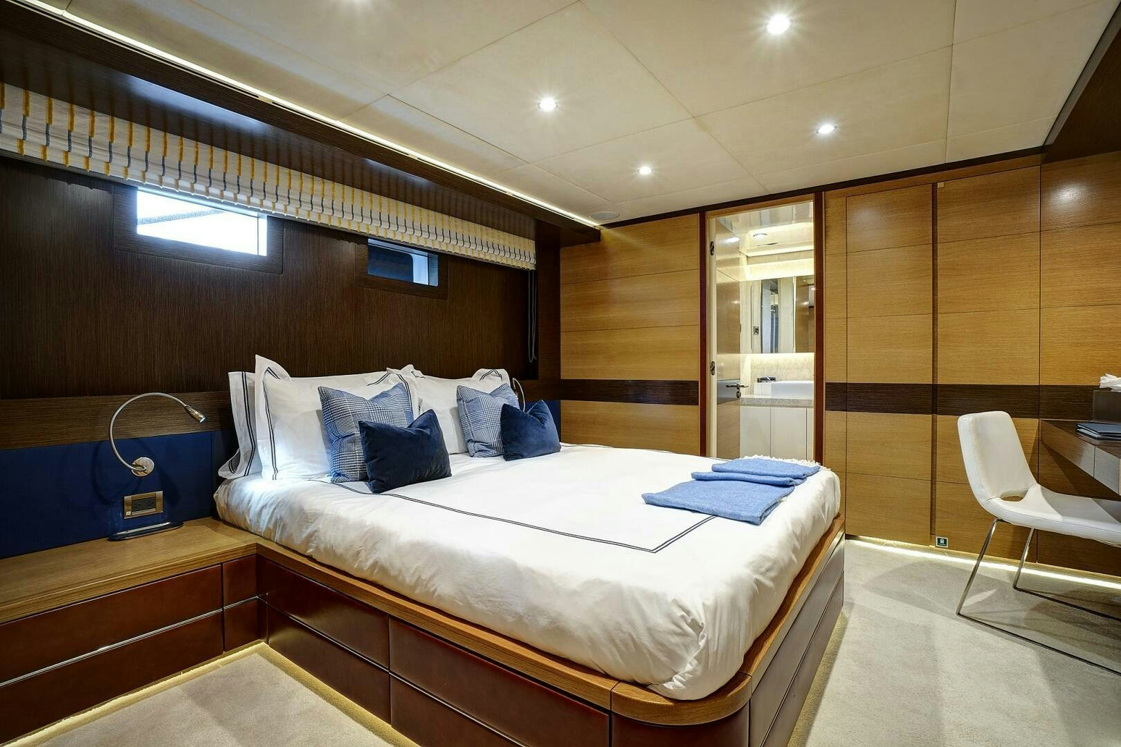 a room with a bed and a chair aboard SWEET CAROLINE Yacht for Sale