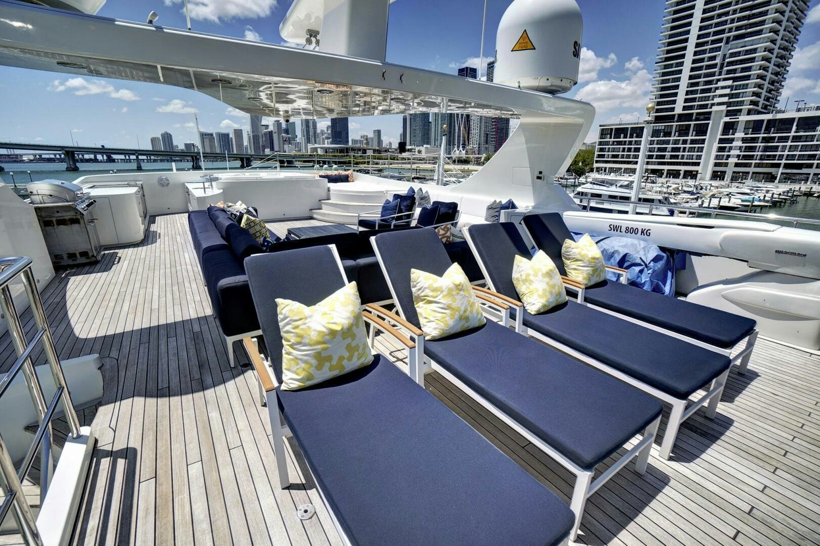 a deck with a table and chairs aboard SWEET CAROLINE Yacht for Sale