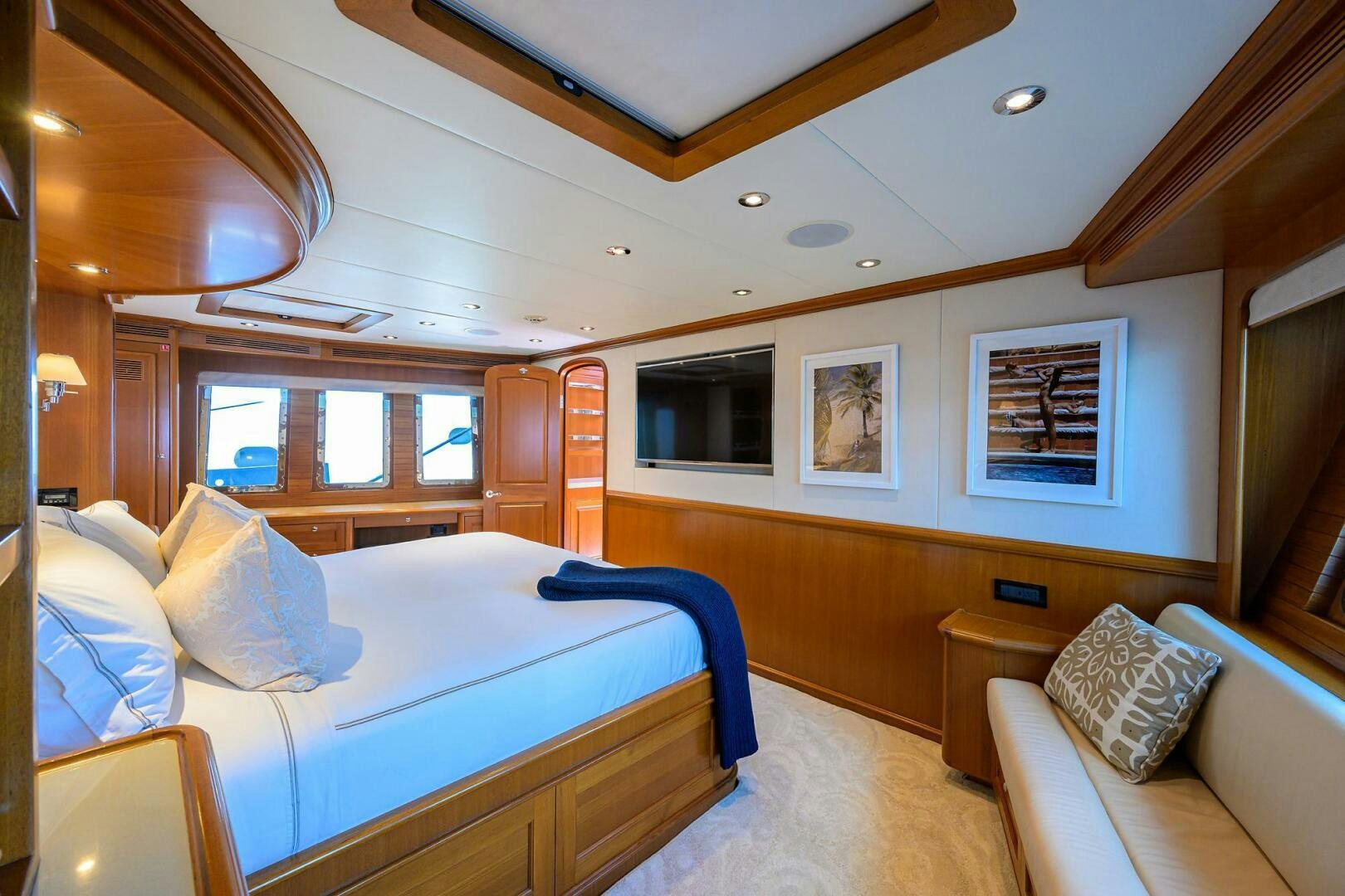 a bedroom with a bed and a couch aboard SOLACE Yacht for Sale