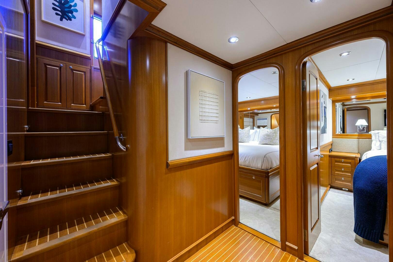 a bedroom with a wood closet aboard SOLACE Yacht for Sale