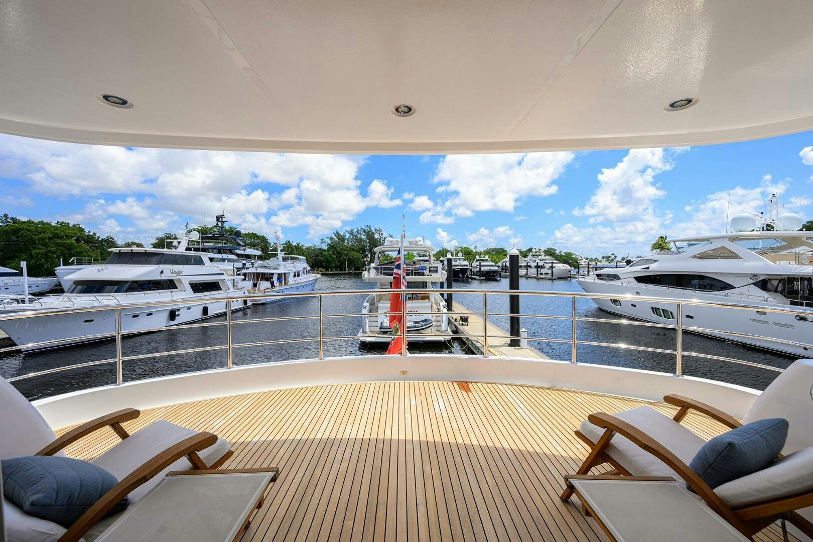 a deck with boats and chairs aboard SOLACE Yacht for Sale