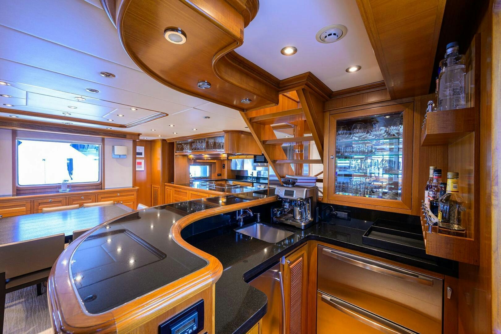 a kitchen with wooden cabinets aboard SOLACE Yacht for Sale