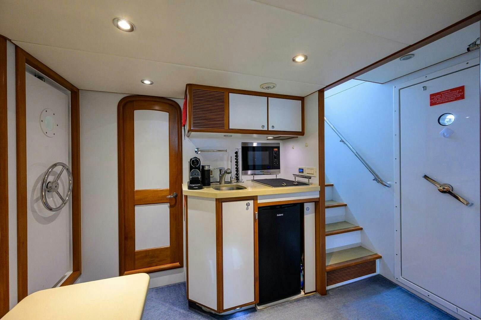a kitchen with white cabinets aboard SOLACE Yacht for Sale