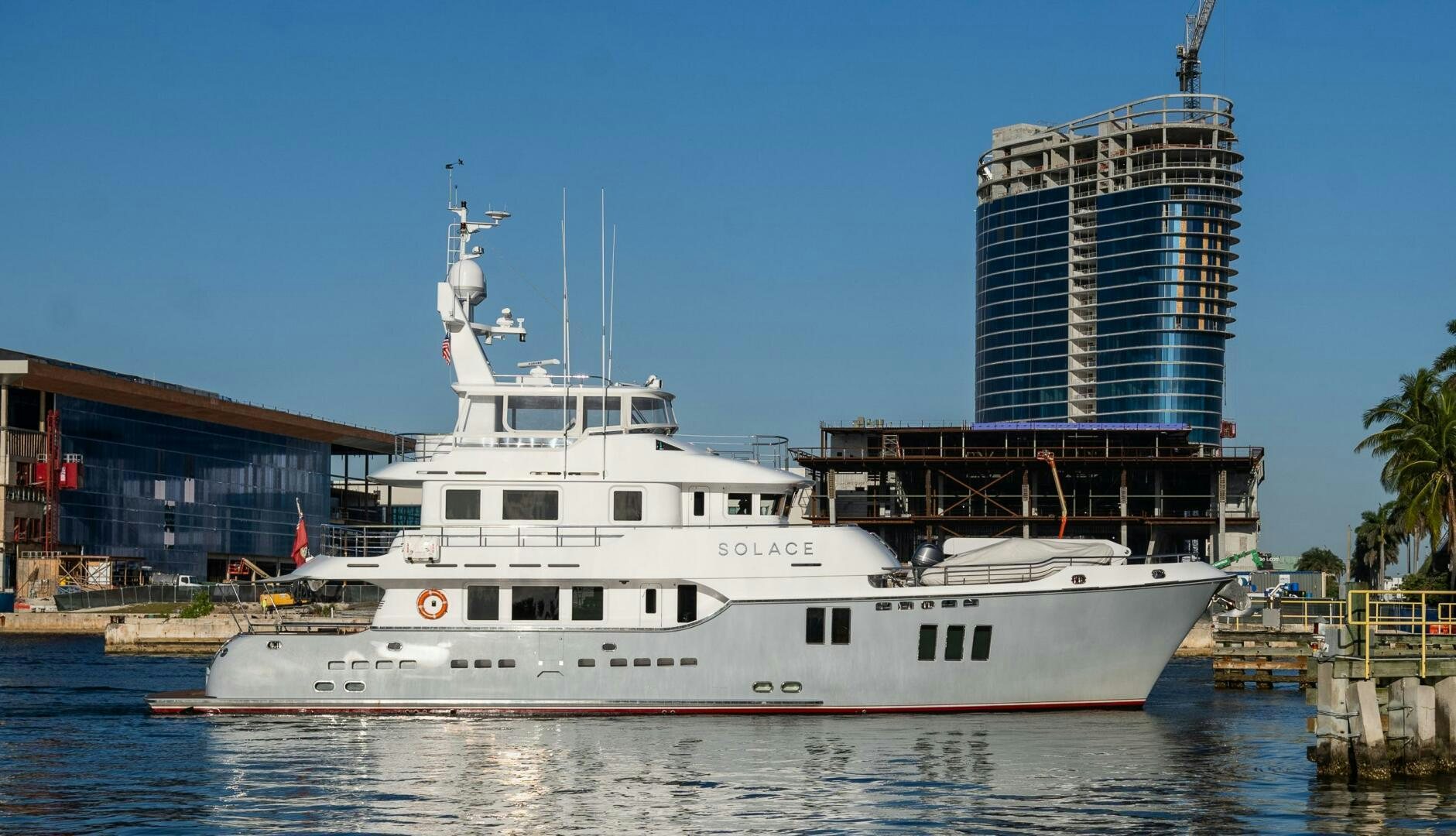 a large white boat in a harbor aboard SOLACE Yacht for Sale
