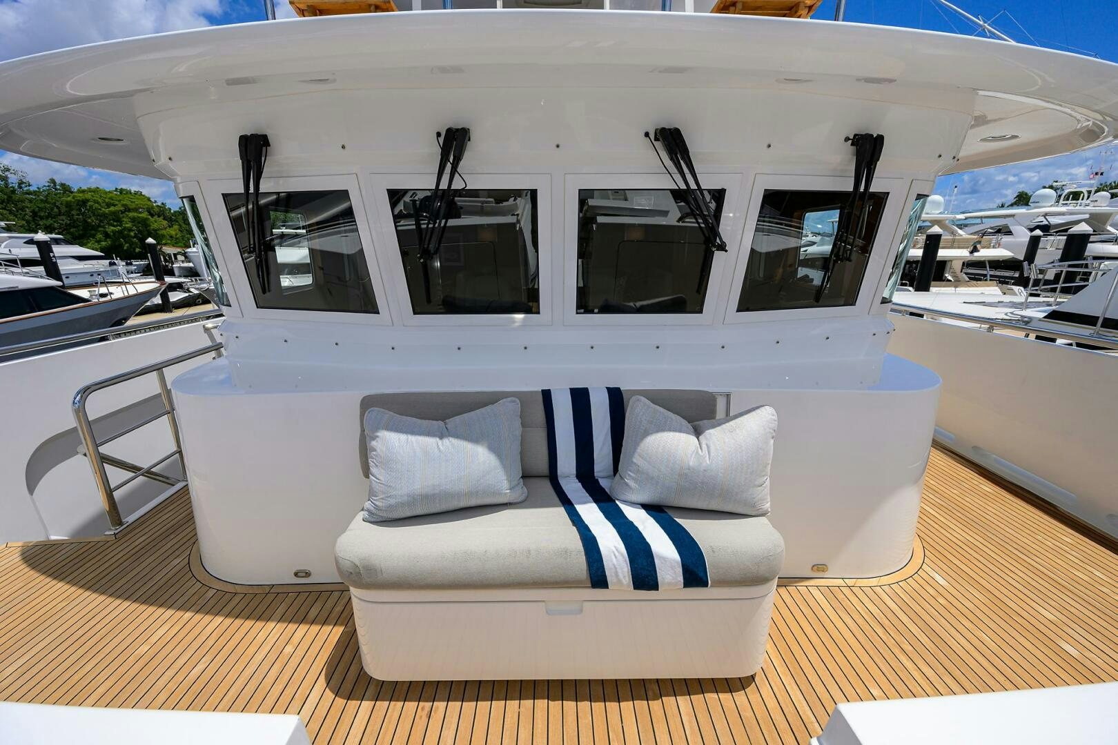 a white boat with blue and white stripes on the front aboard SOLACE Yacht for Sale