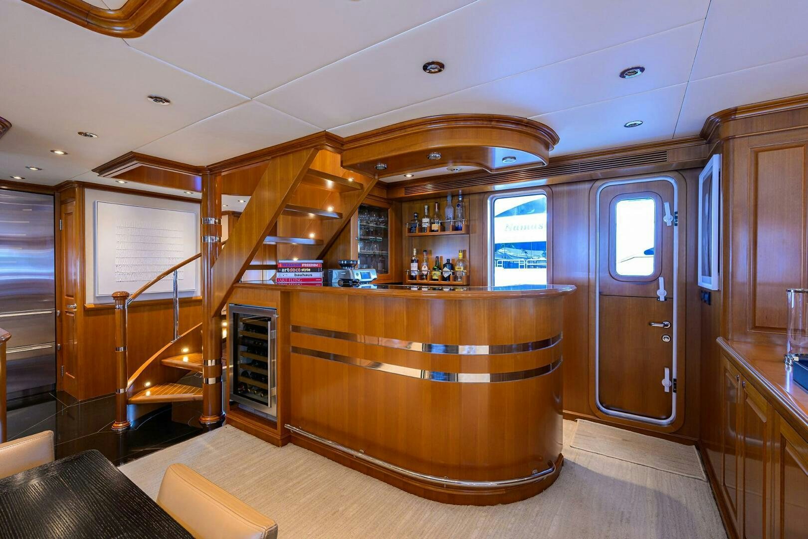 a room with a bar and a staircase aboard SOLACE Yacht for Sale