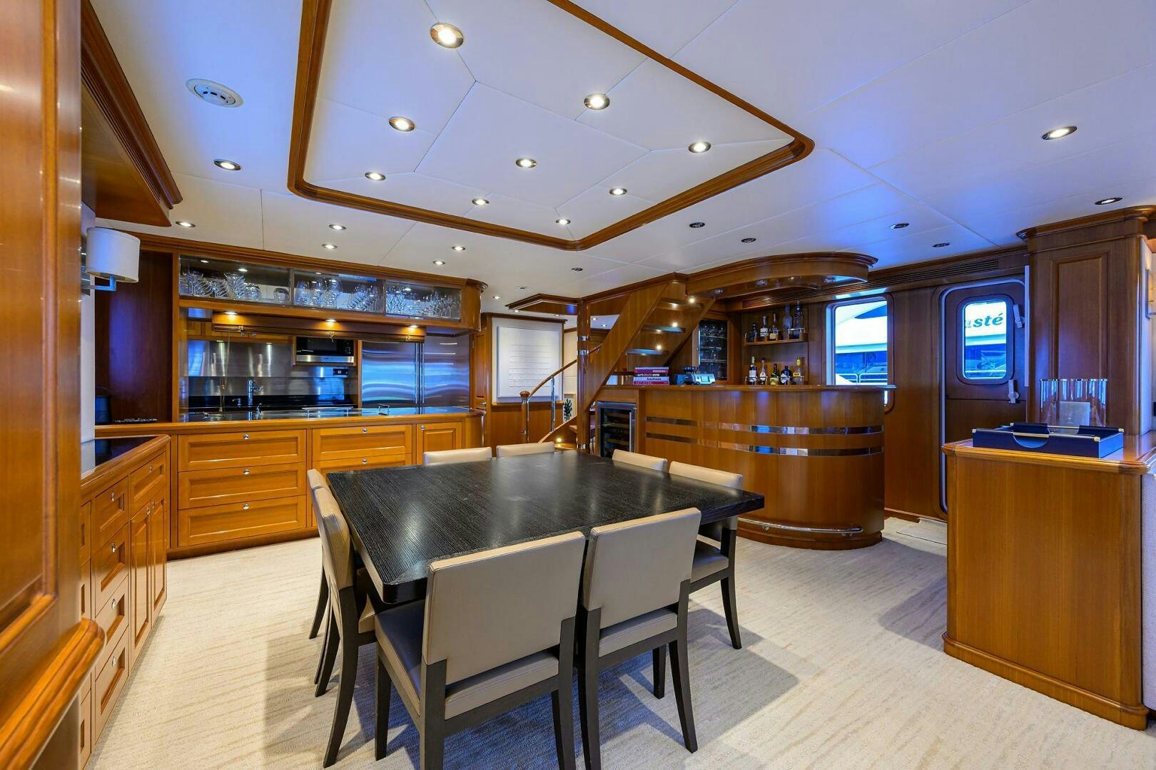 a kitchen with a bar and a table aboard SOLACE Yacht for Sale
