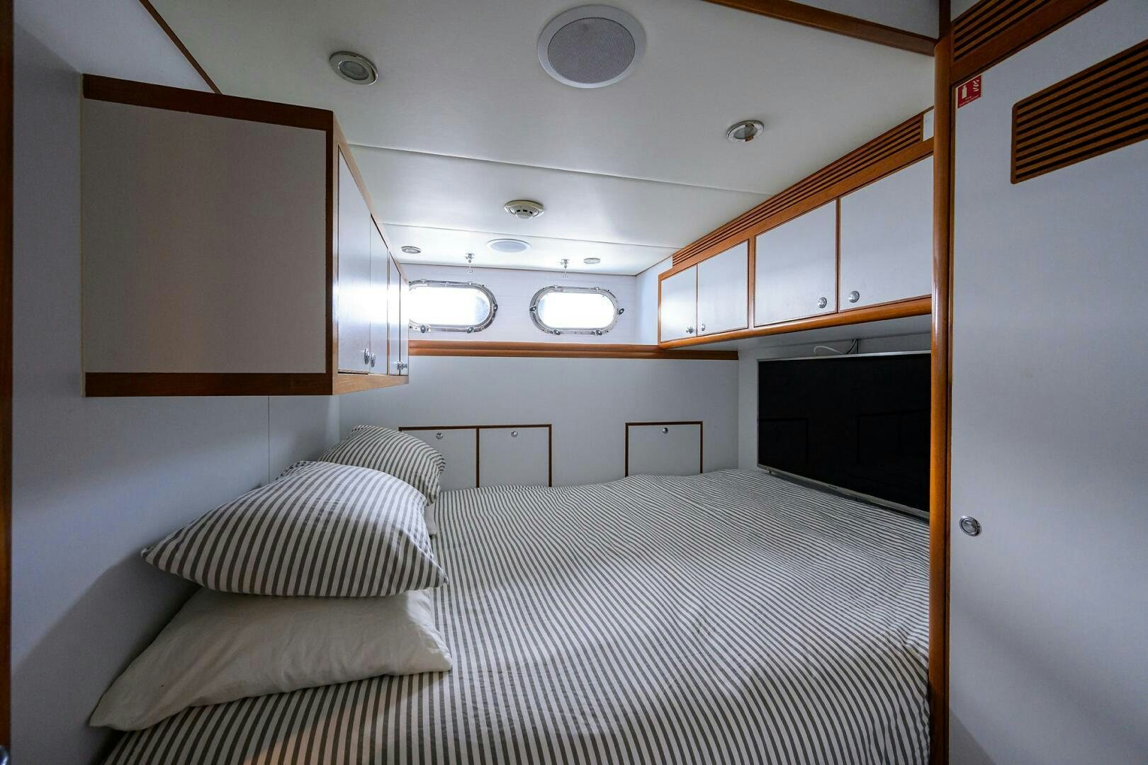 a room with a bed and a television aboard SOLACE Yacht for Sale