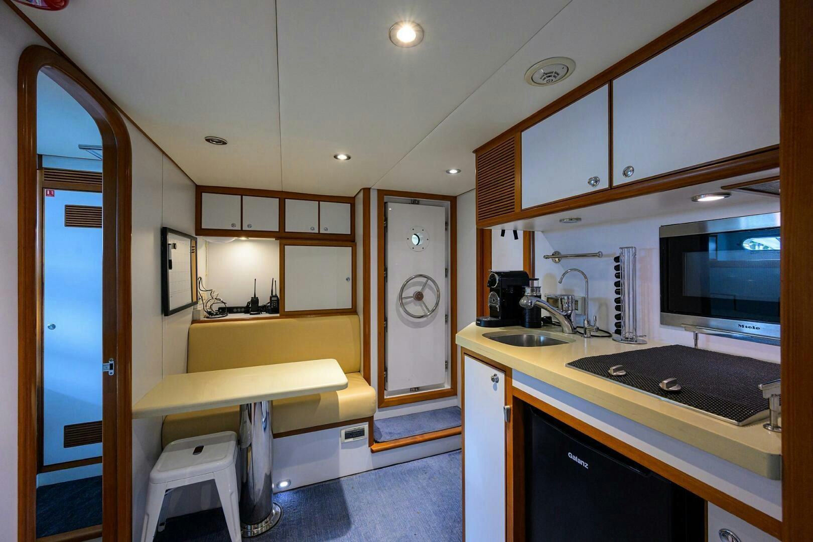 a kitchen with a sink and a microwave aboard SOLACE Yacht for Sale