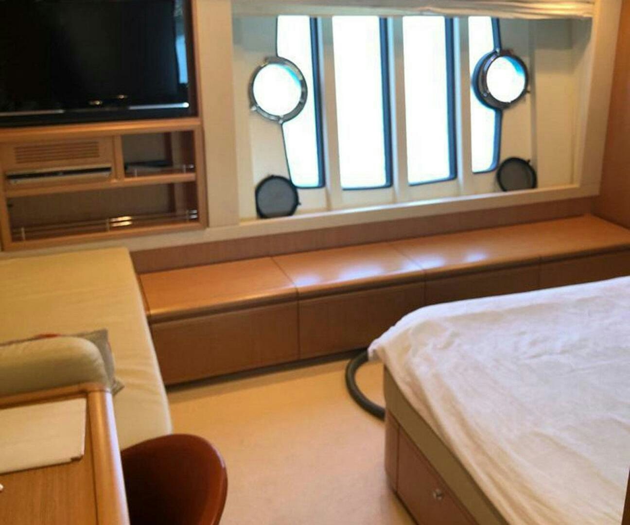 a room with a bed and a television aboard MAR AZUL Yacht for Sale