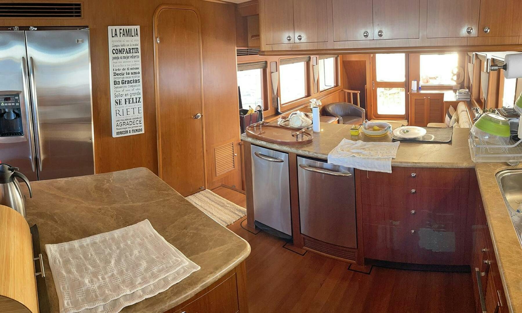 a kitchen with wooden cabinets aboard BRAVO! Yacht for Sale