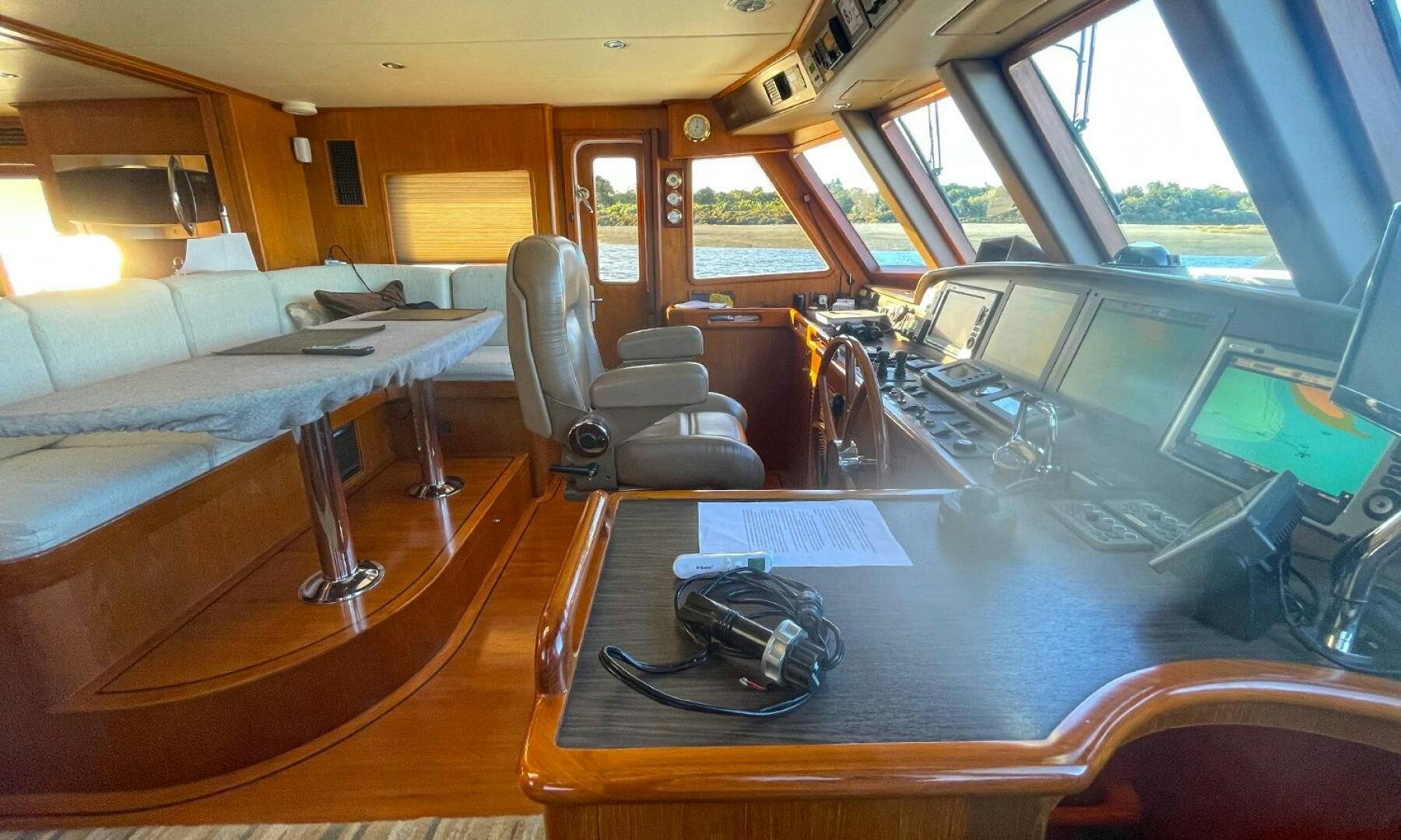 a room with a table and chairs aboard BRAVO! Yacht for Sale