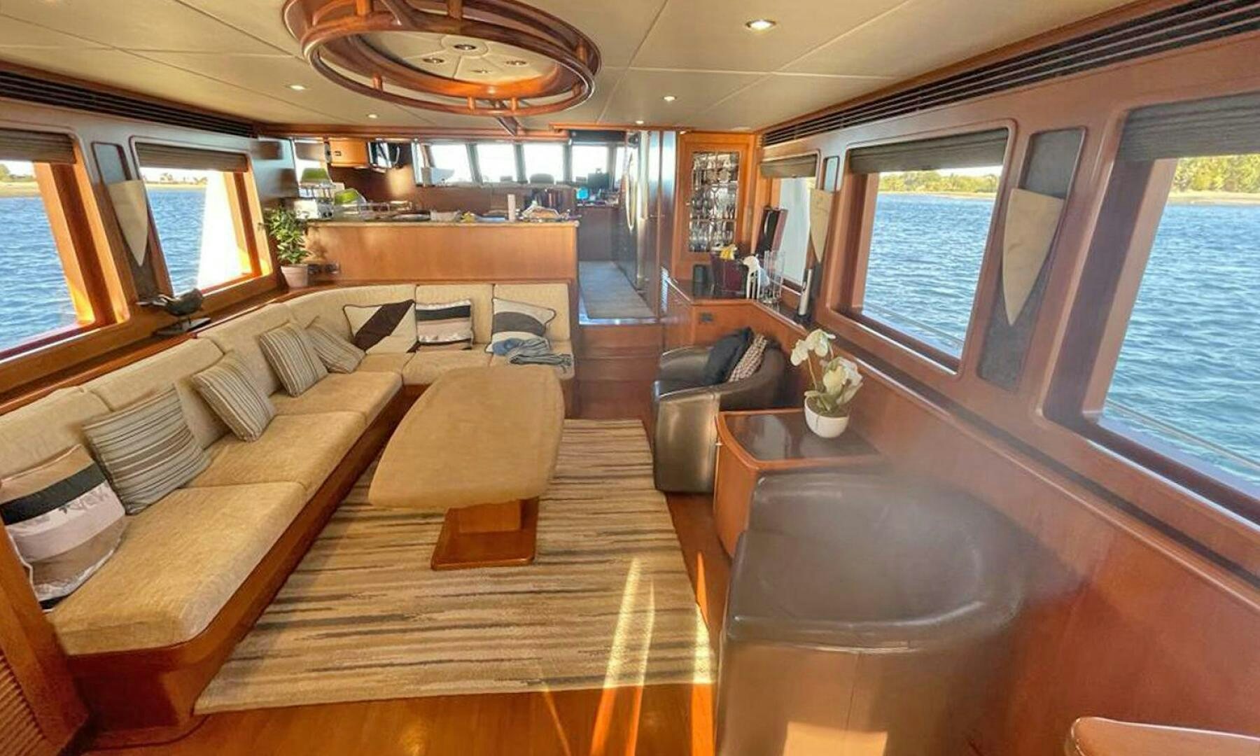 a large living room with a large window aboard BRAVO! Yacht for Sale