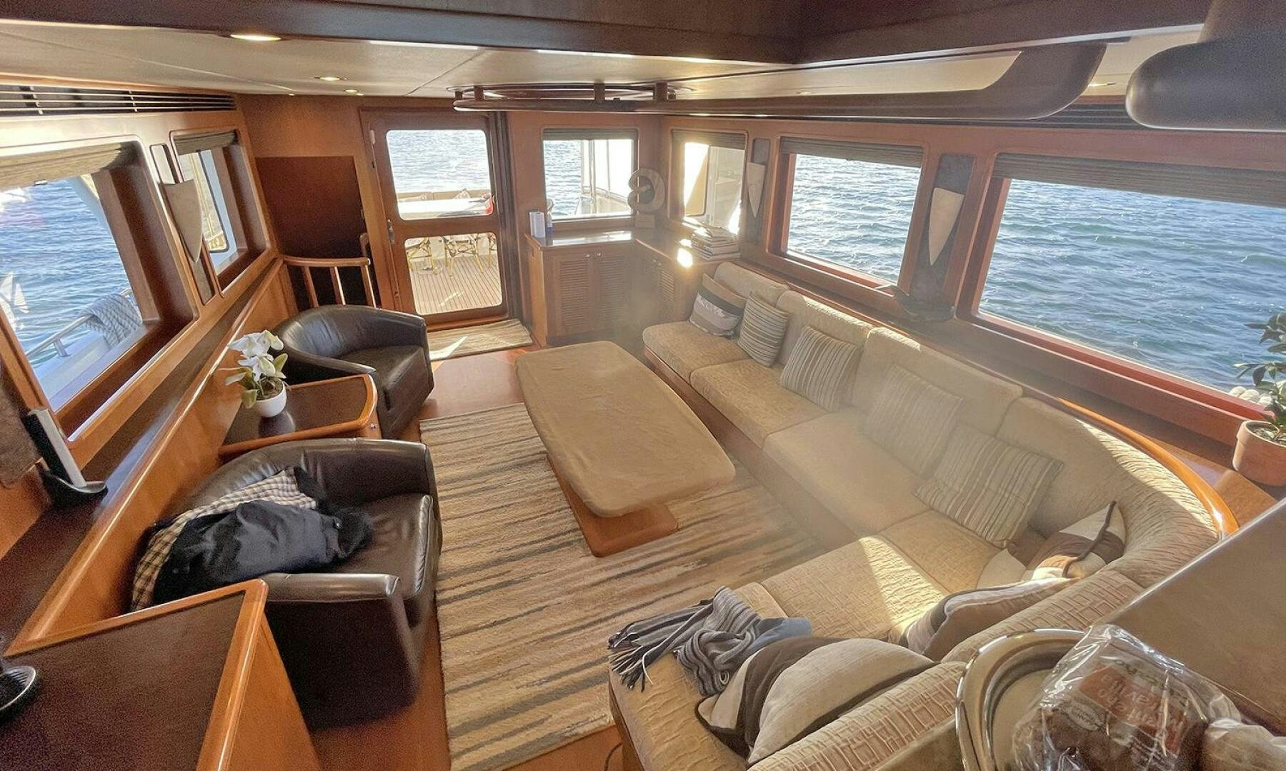 a living room with a large window aboard BRAVO! Yacht for Sale