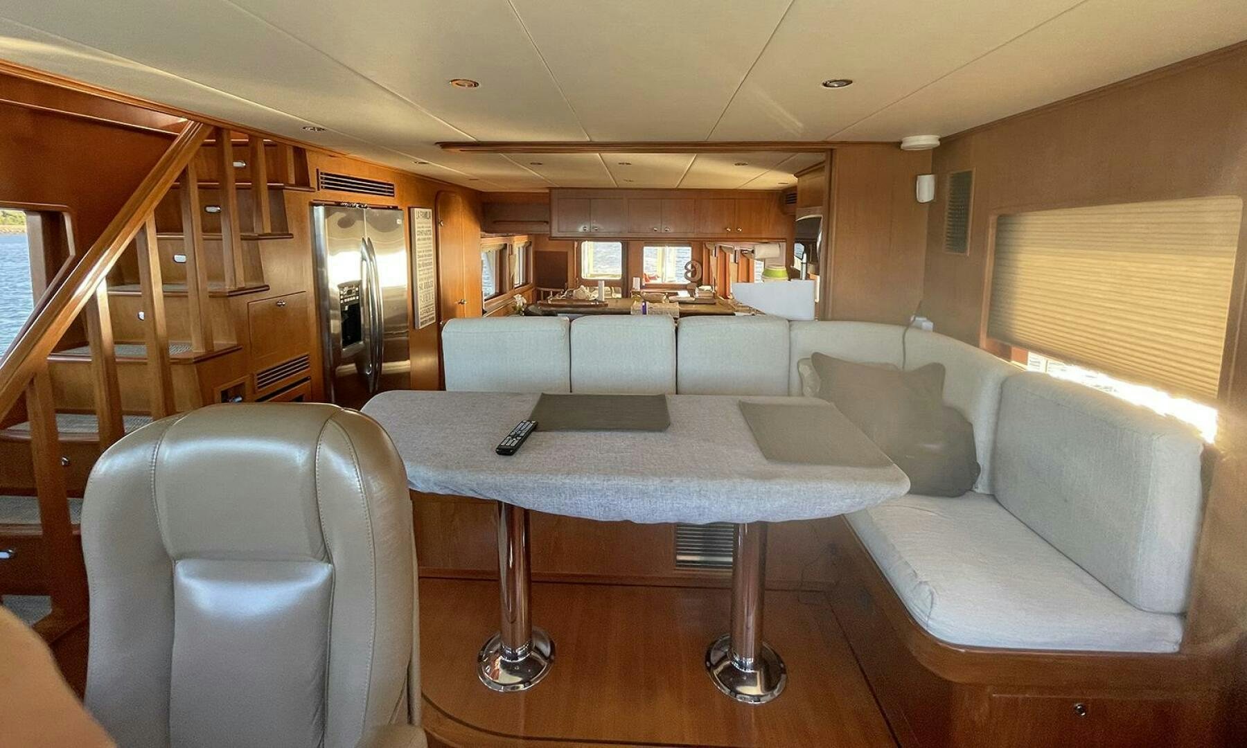 a living room with a table and chairs aboard BRAVO! Yacht for Sale