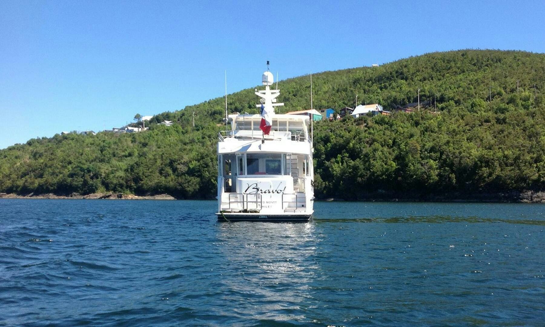 a small white boat in the water aboard BRAVO! Yacht for Sale