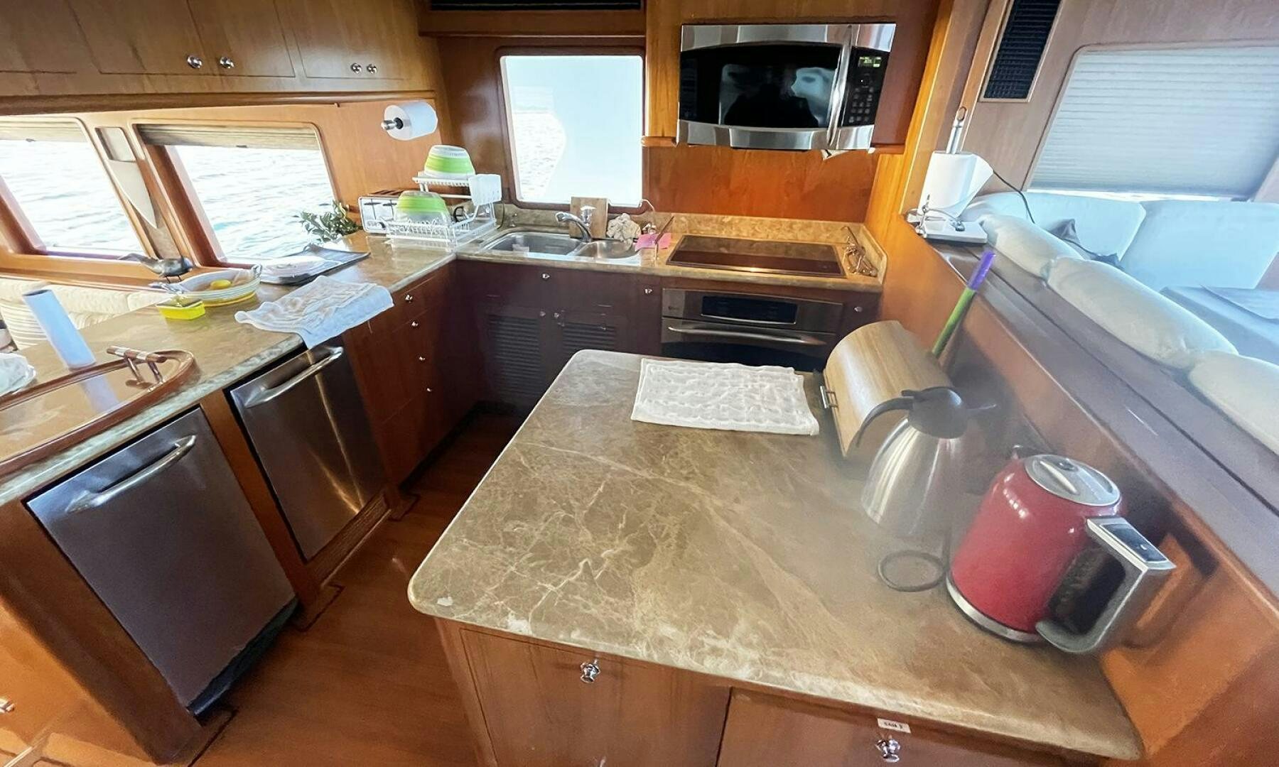 a kitchen with wooden cabinets aboard BRAVO! Yacht for Sale